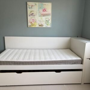 Flaxa white single bed frame with extended pull-out trundle bed and red backpanel storage headboard shelf system in Abu Dhabi