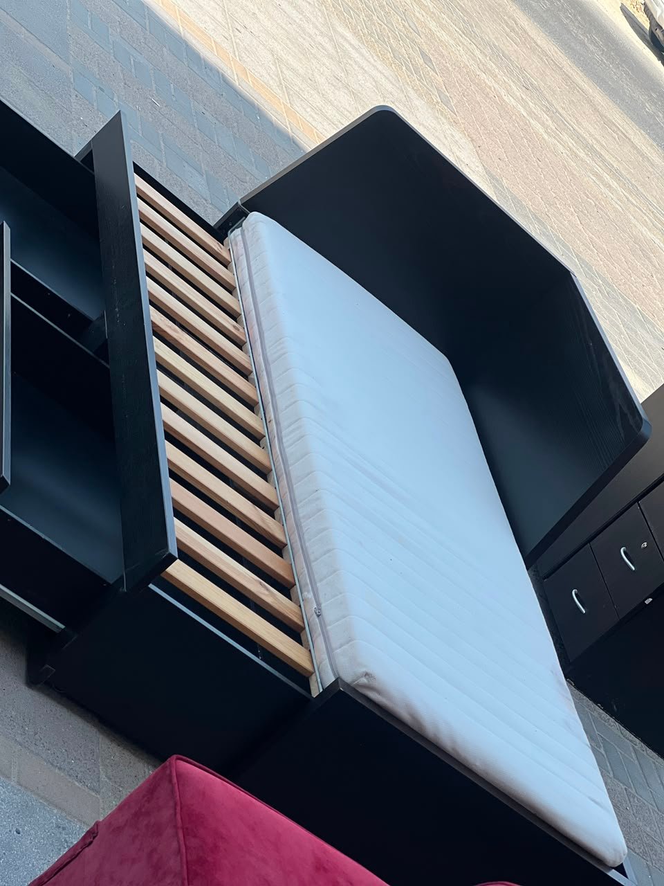 Modern black wooden used daybed frame with open storage drawers displayed