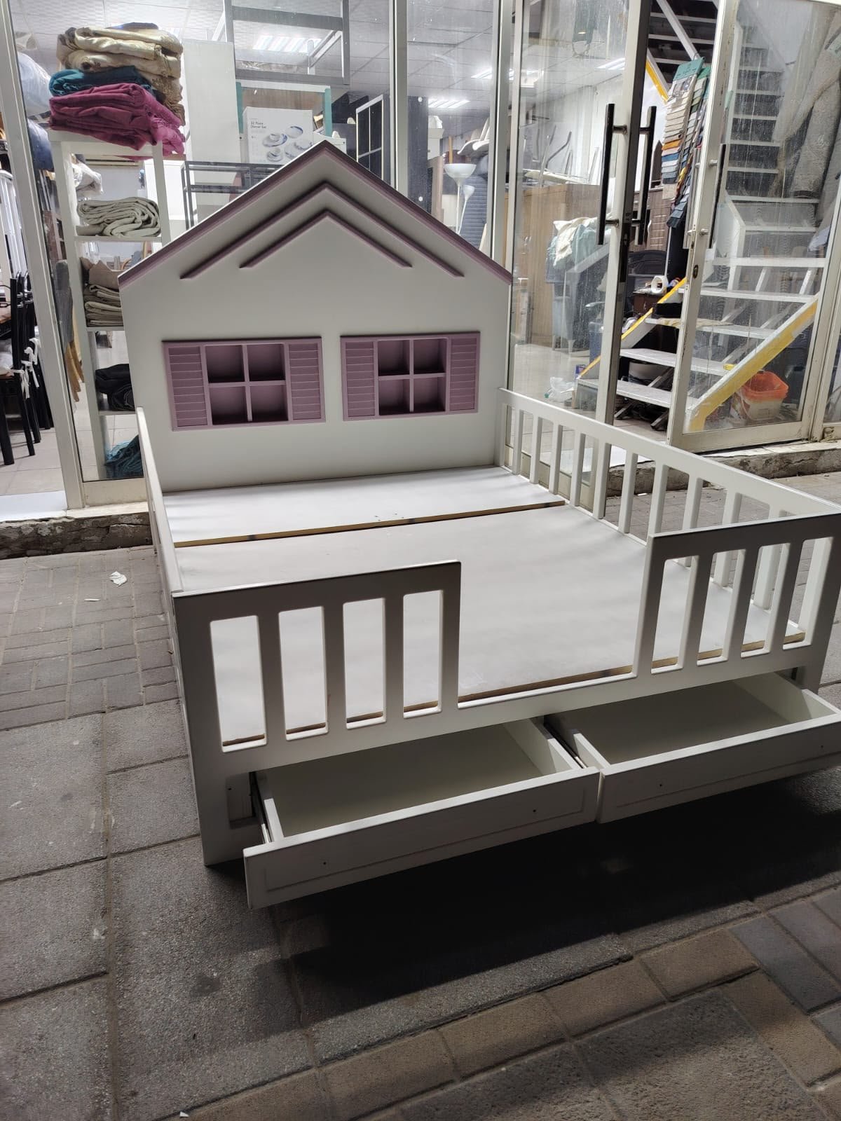 White and purple house shaped wooden used kids bed in Abu Dhabi with safety rails and window