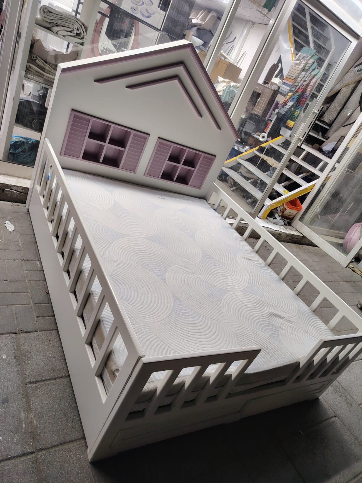 White and purple house shaped wooden used kids bed in Abu Dhabi with safety rails