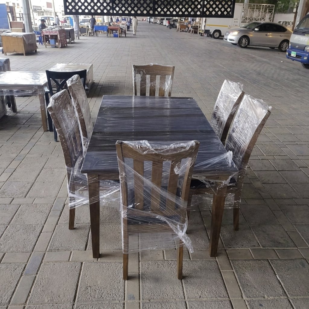 Modern dark wood 6-seater rectangular dining table set wrapped and protected with 6 matching chairs at Fairy of Fortune Used Furniture Abu Dhabi