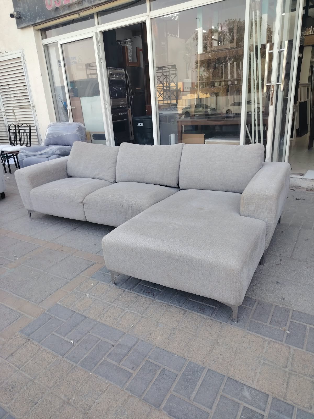 Modern light grey L-shaped sectional fabric sofa with chaise lounge and metal legs