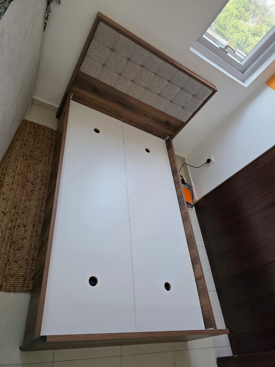 Modern wooden used single bed frame with gray tufted upholstered headboard at Fairy of Fortune Used Furniture Abu Dhabi