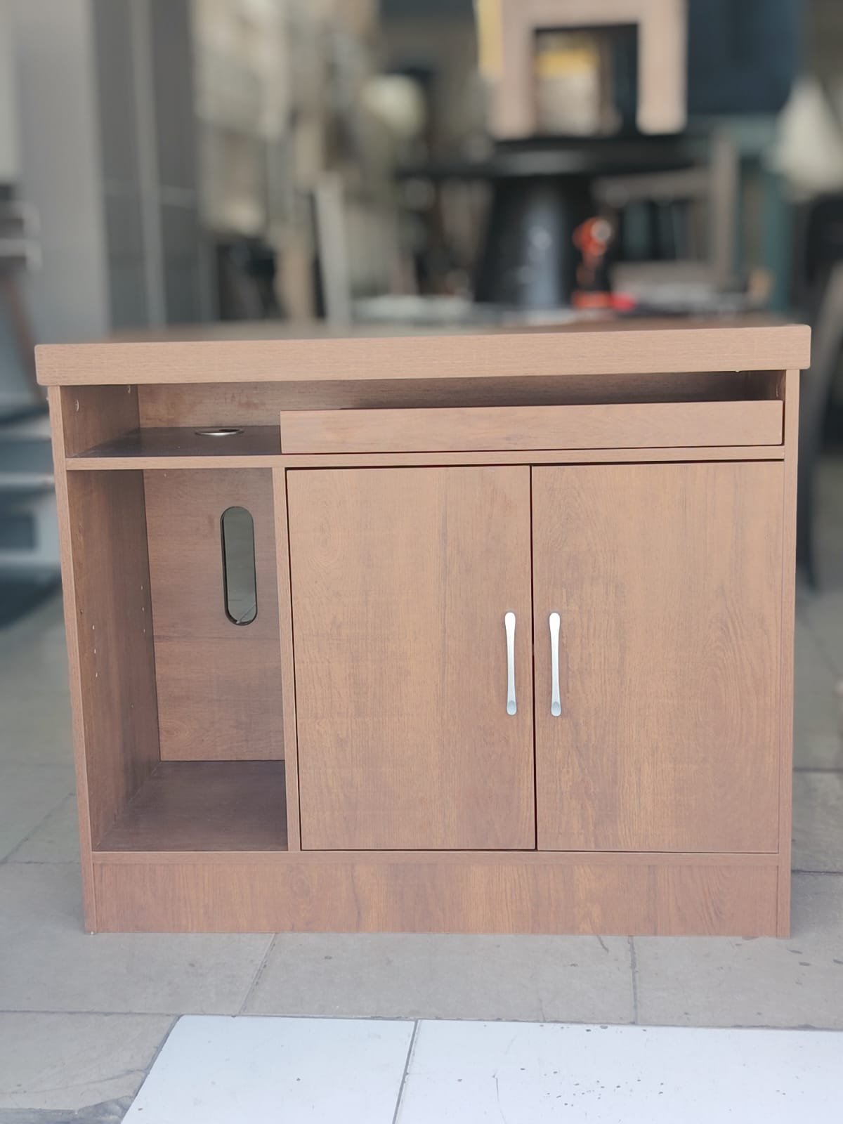 Compact brown wood-grain office sideboard and computer workstation storage cabinet with open shelf and cabinet door at Fairy of Fortune Used Furniture Abu Dhabi