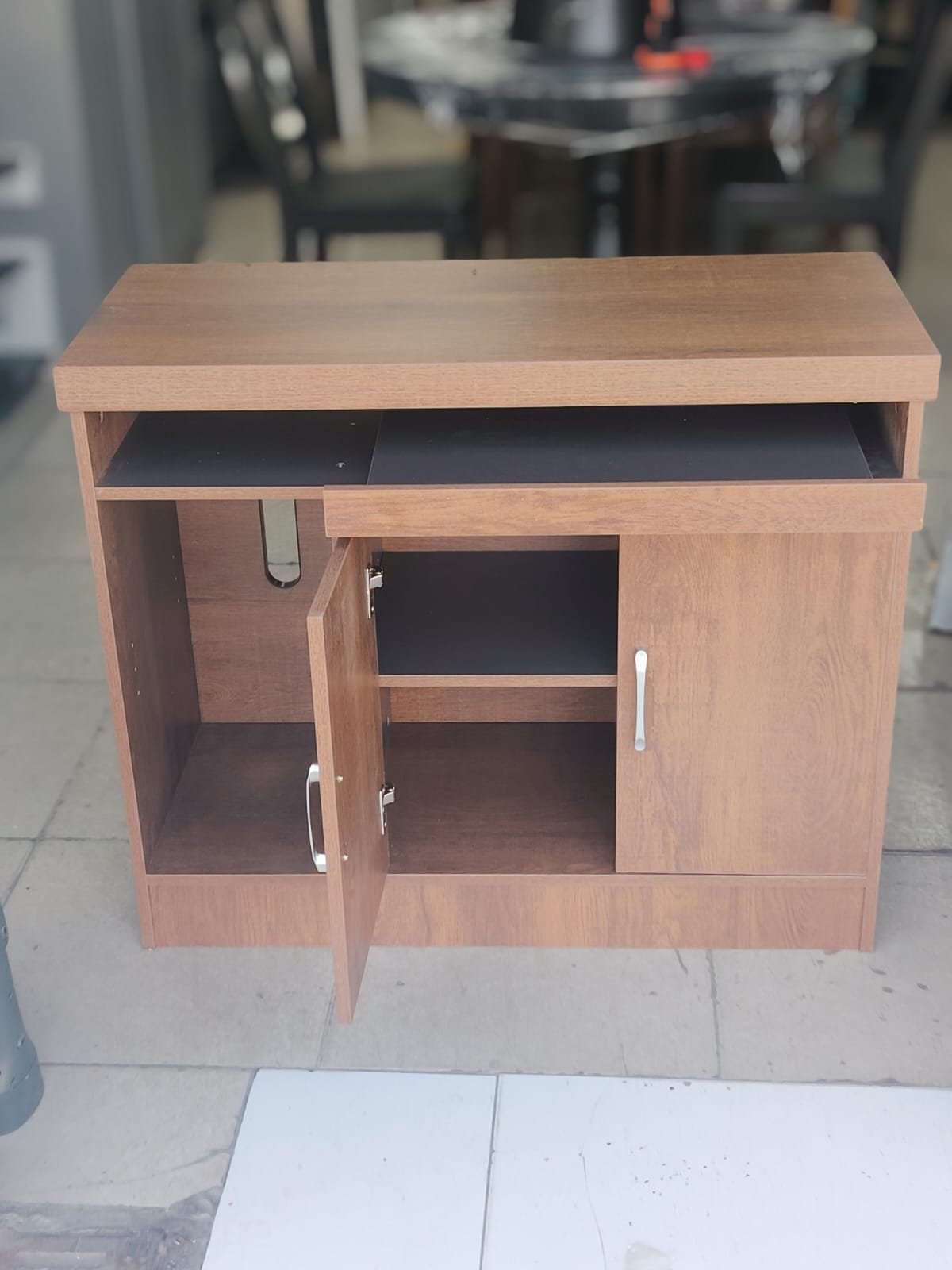 Compact brown wood-grain office sideboard and computer workstation storage cabinet with open shelf and cabinet door