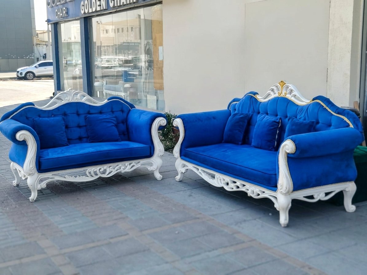 Elegant 2-piece royal blue velvet sofa set with intricate carved white wooden frames and matching accent cushions at Fairy of Fortune Used Furniture Abu Dhabi