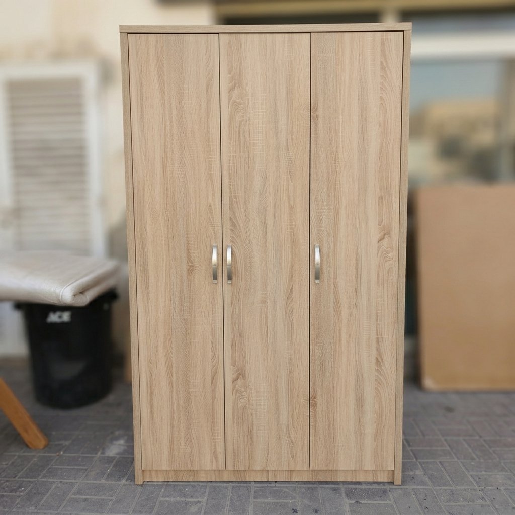 Modern light oak 3 door wooden wardrobe closet with clothes hanging rail and storage shelves at Fairy of Fortune Used Furniture Abu Dhabi