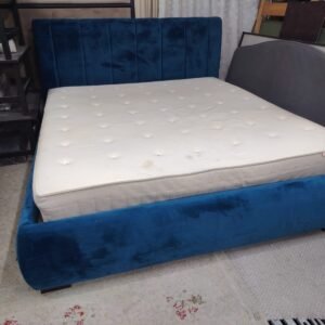 Luxury royal blue velvet upholstered double bed frame featuring a vertical channel-tufted headboard and thick comfortable mattress at Fairy of Fortune Used Furniture Abu Dhabi