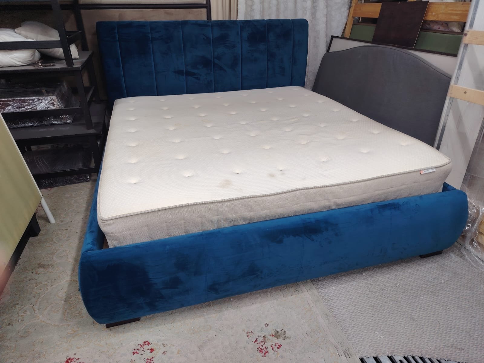 Luxury royal blue velvet upholstered double bed frame featuring a vertical channel-tufted headboard and thick comfortable mattress at Fairy of Fortune Used Furniture Abu Dhabi