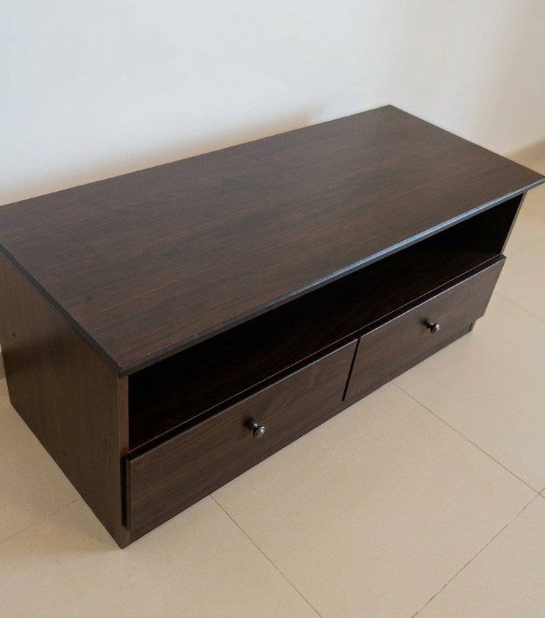 Modern dark brown wooden TV unit table console with open shelf and two drawers at Fairy of Fortune Used Furniture Abu Dhabi